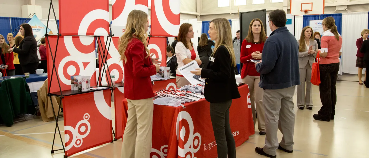 Students visit with health professionals during a career fair on U N E's Portland Campus