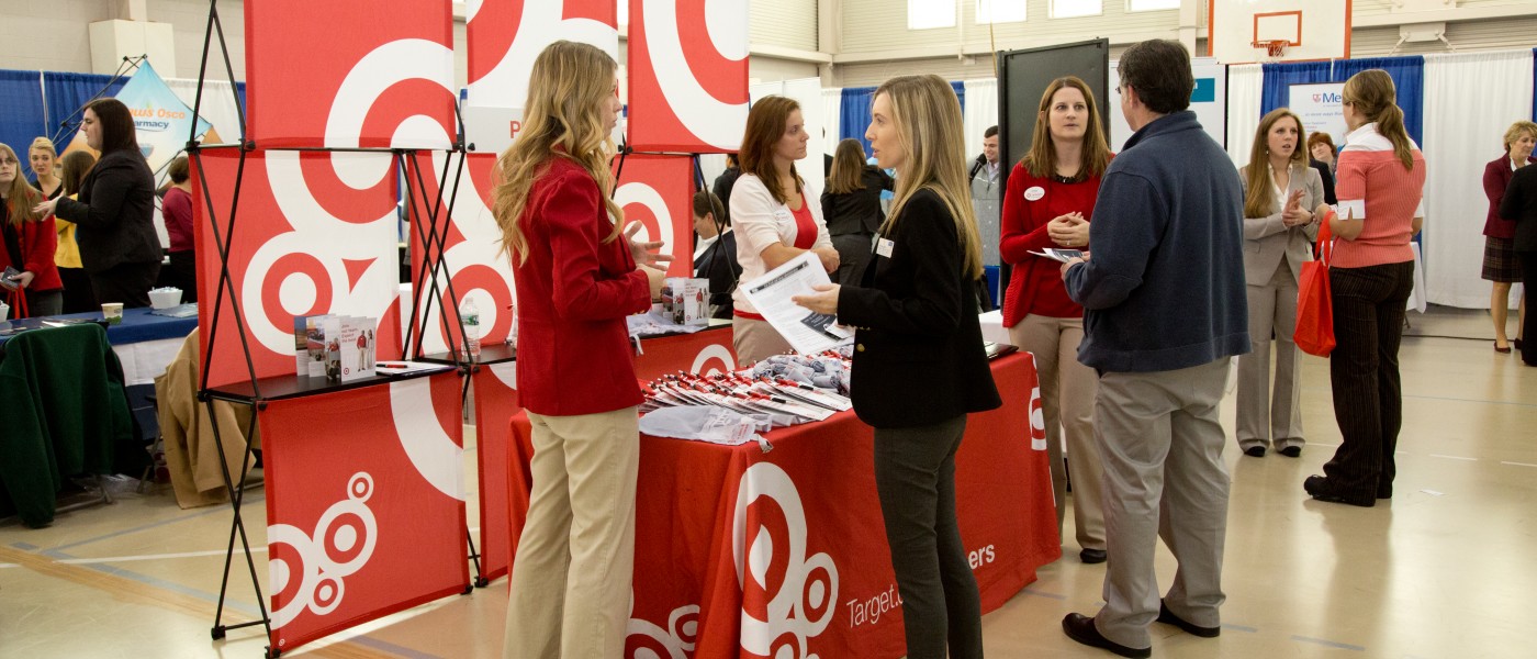 Students visit with health professionals during a career fair on U N E's Portland Campus 