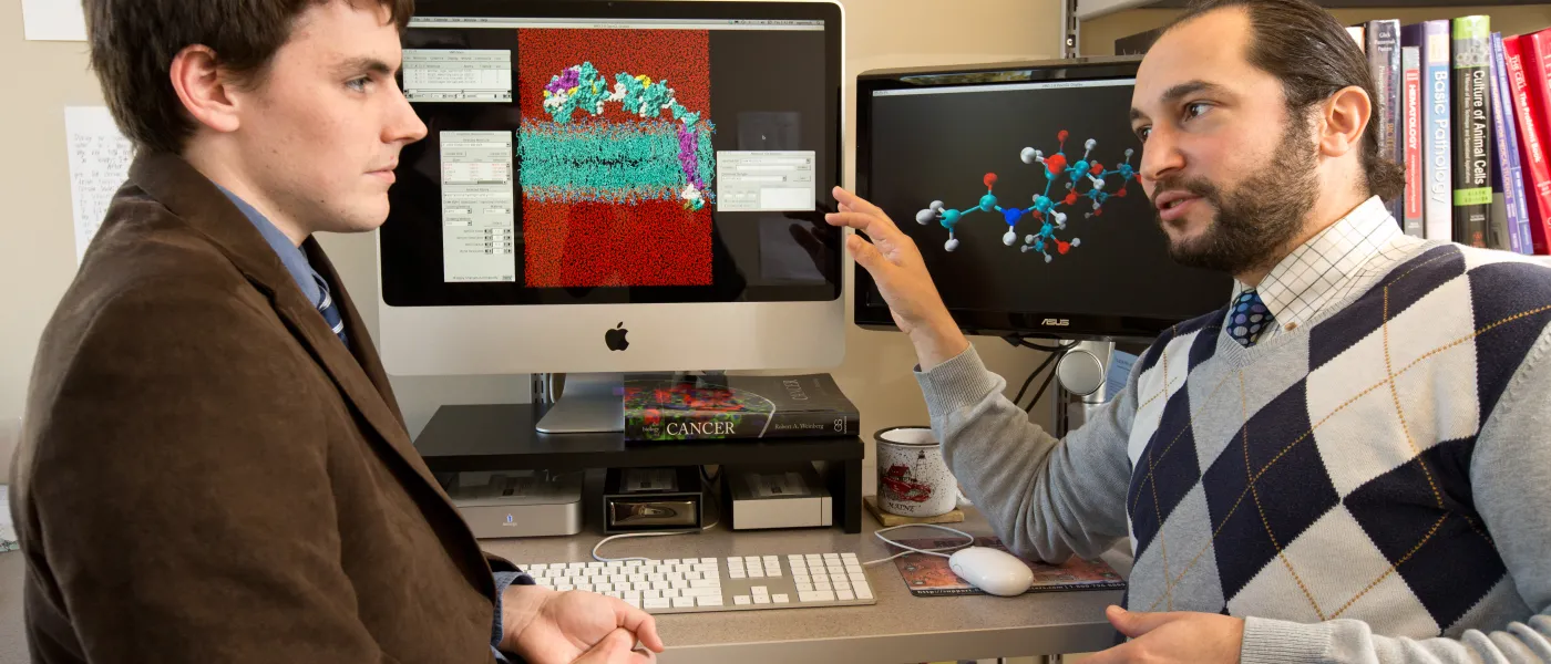 U N E professor and Student by a molecular model on a computer