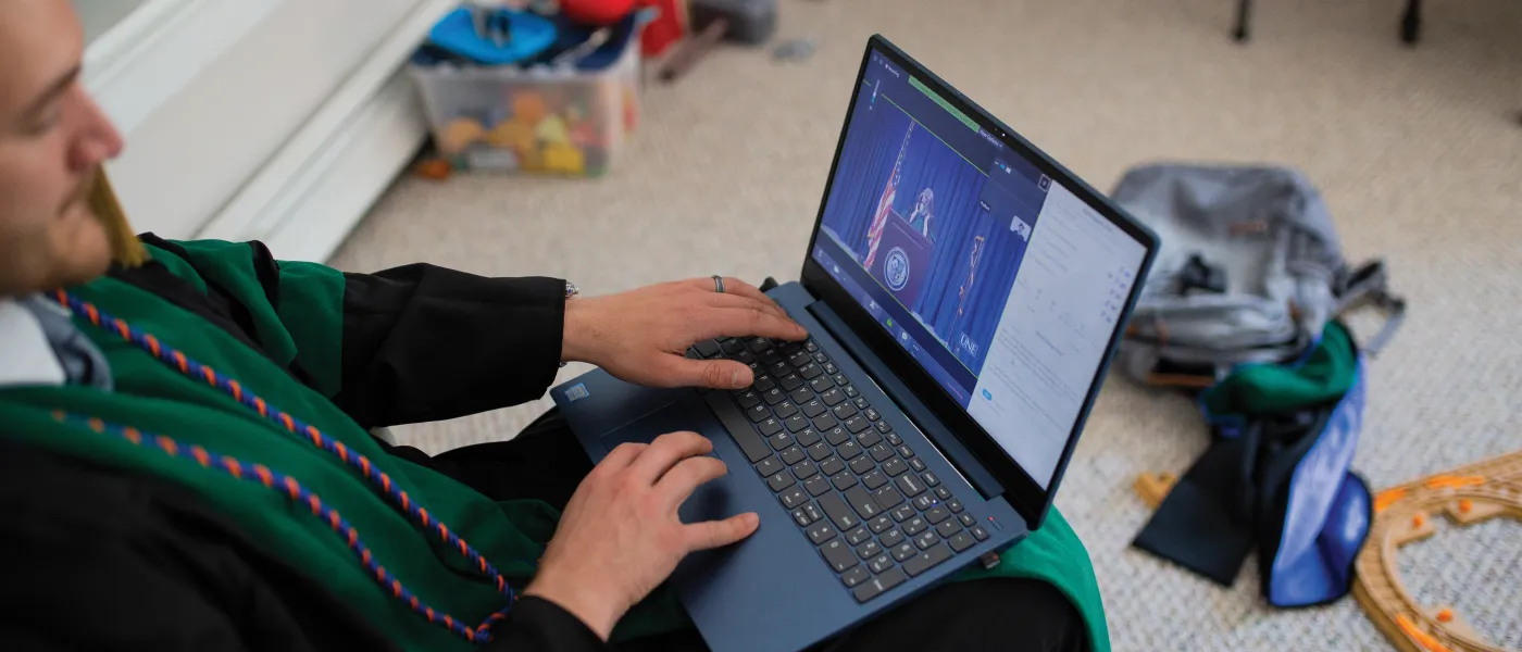 David Shbeeb watches the 2020 COM Commencement ceremony from home.