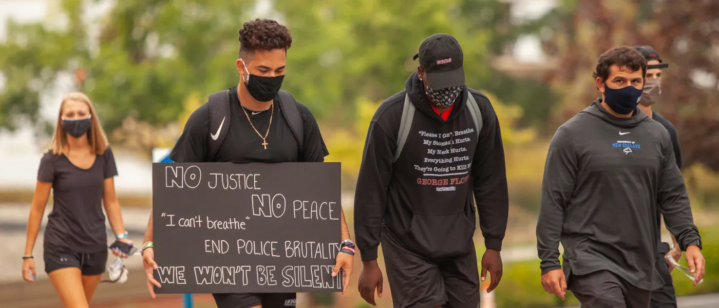 students participate in the march for social justice held on the biddeford campus