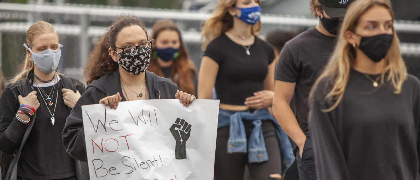 students walk in the march for social justice held on the biddeford campus