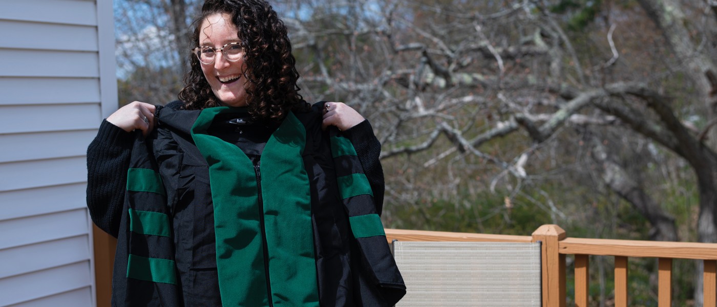 Rebecca Greenspan, D.O., ’20, smiles as she takes part in her virtual hooding ceremony.