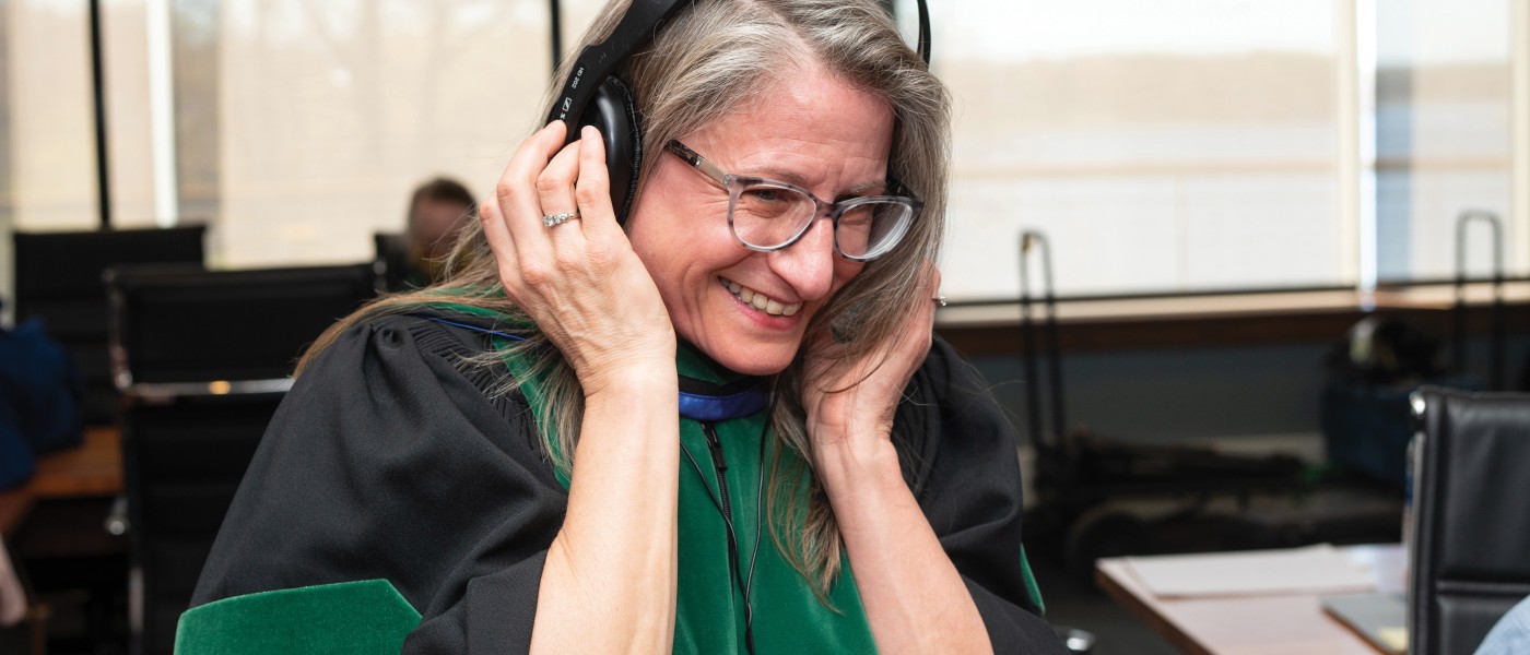 Jane Carreiro, D.O., vice president for Health Affairs and dean of U N E COM, listens to Commencement remarks as they are recorded.