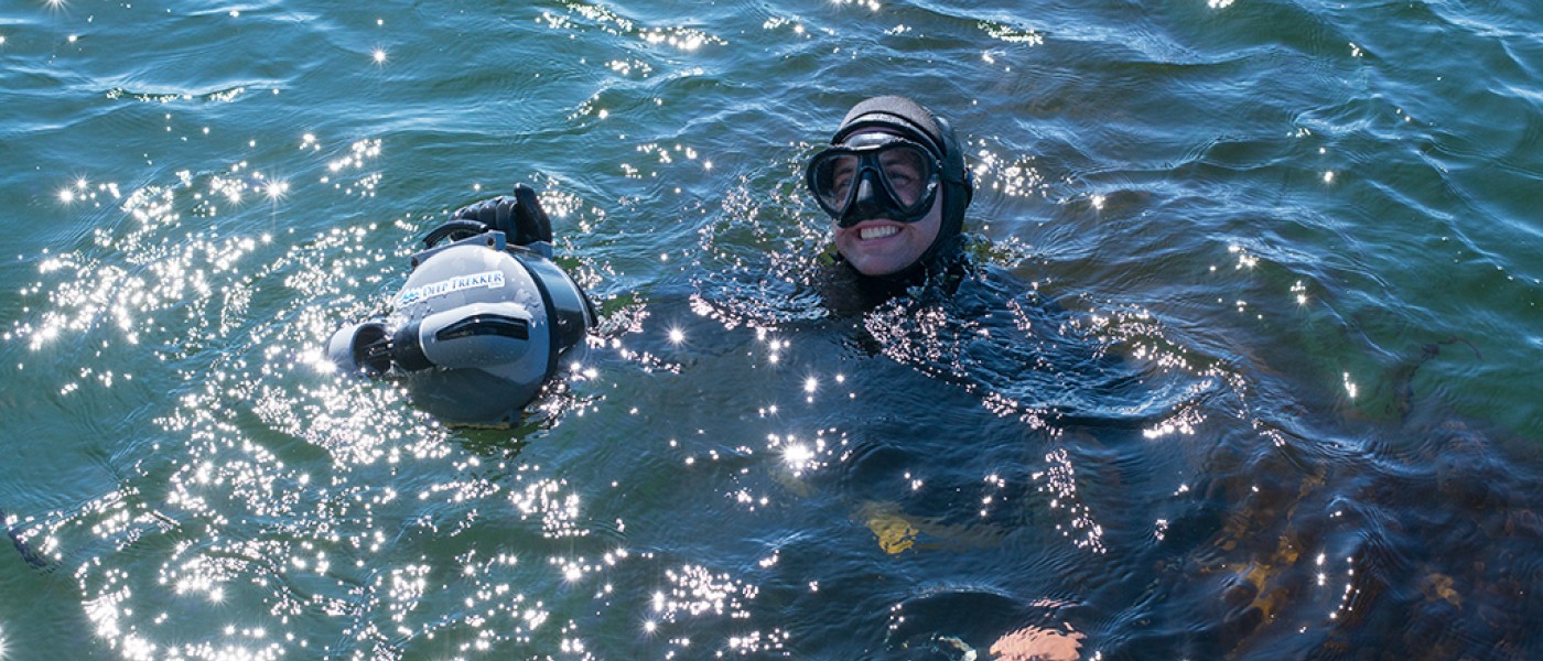 Two U N E students wear snorkeling equipment in the ocean
