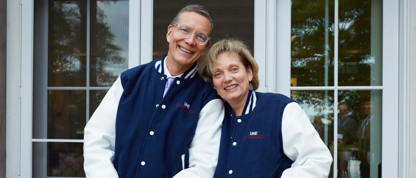 President James Herbert and his wife Lynn wearing varsity jackets