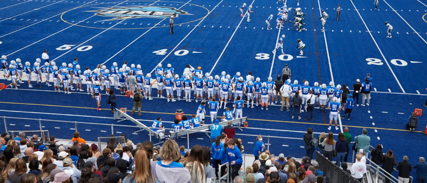 Crowd watching the U N E football team during a game