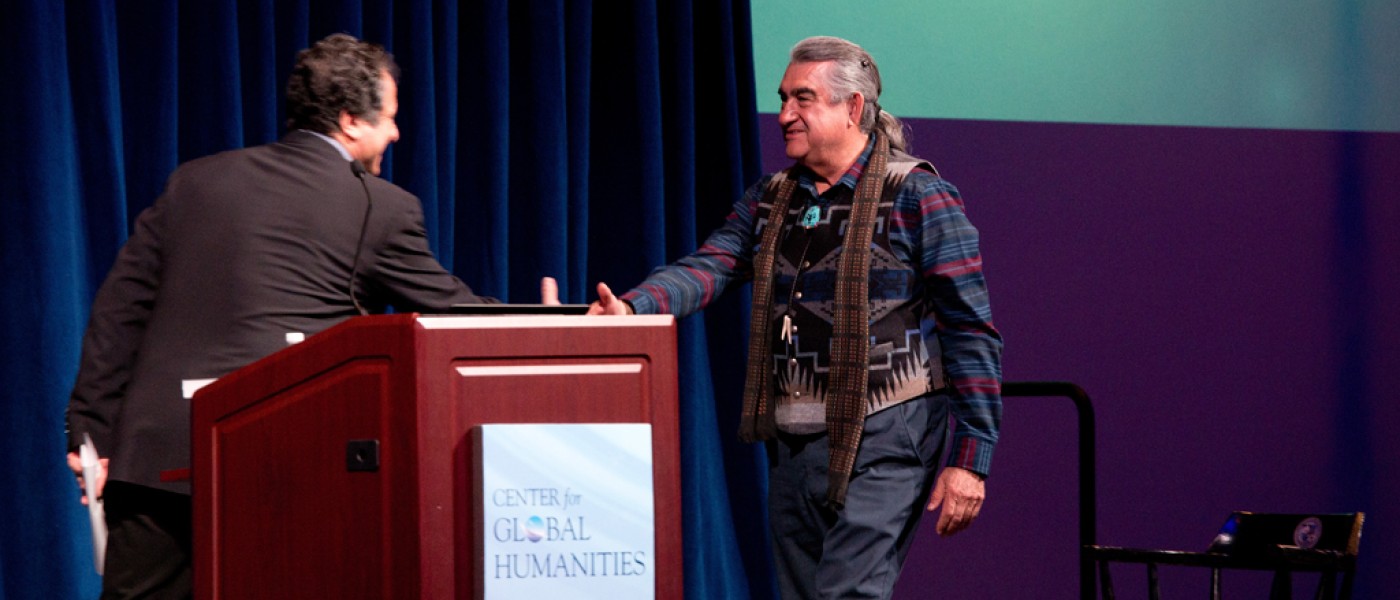 Lecturers shaking hands at a Center for Global Humanities event