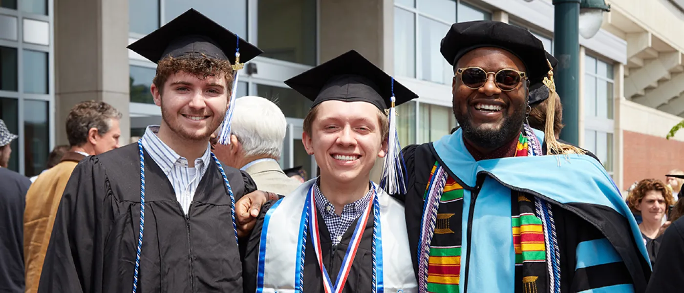 Undergraduate and doctoral students pose for a photo outside the Cross Insurance Arena in Portland