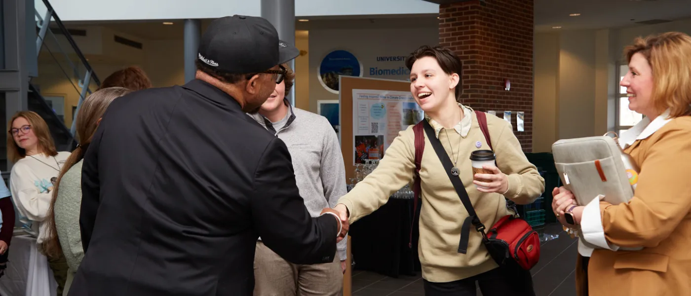 Reverend Lennox Yearwood shakes hands with a student after the Climate and Justice Teach-In