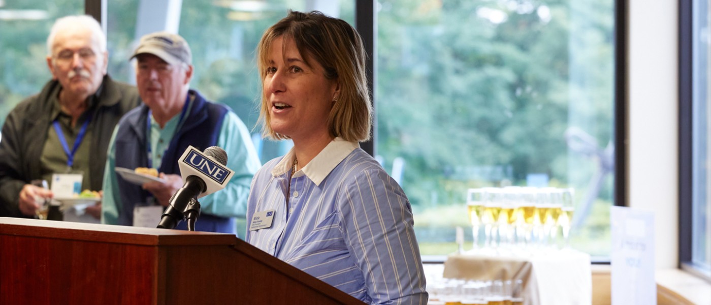 A speaker presents to St. Francis alumni at 2022 Homecoming Weekend before a champagne toast