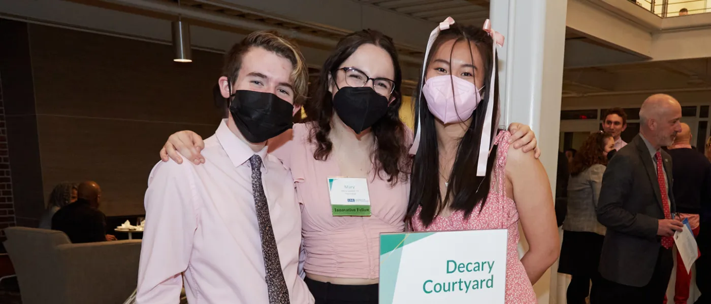 Three U N E students standing together at the Innovation Showcase