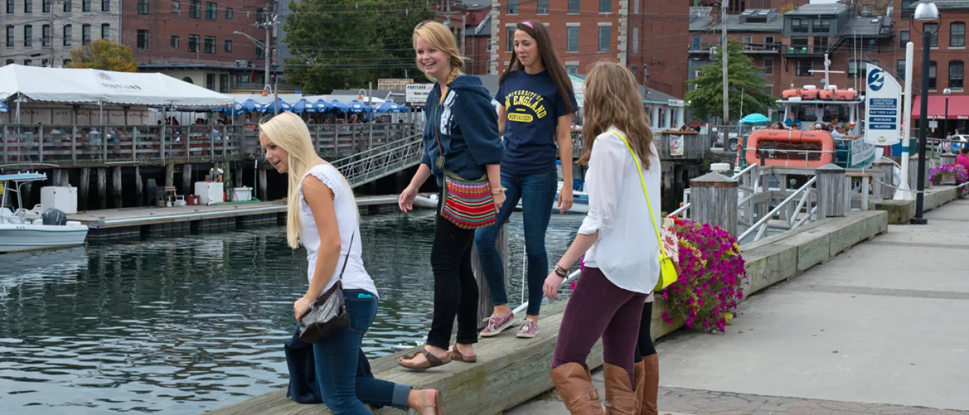 Four students overlooking the water in downtown Portland, Maine