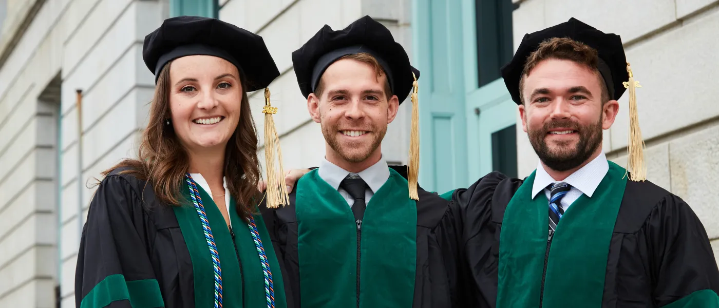 UNE COM graduates pose at Merrill Auditorium in Portland