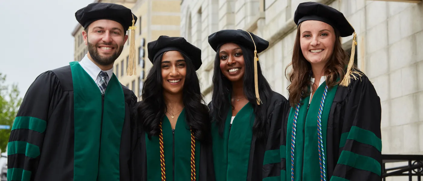UNE COM graduates pose at Merrill Auditorium in Portland