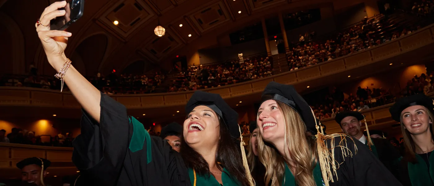 UNE COM graduates take a selfie at Merrill Auditorium in Portland