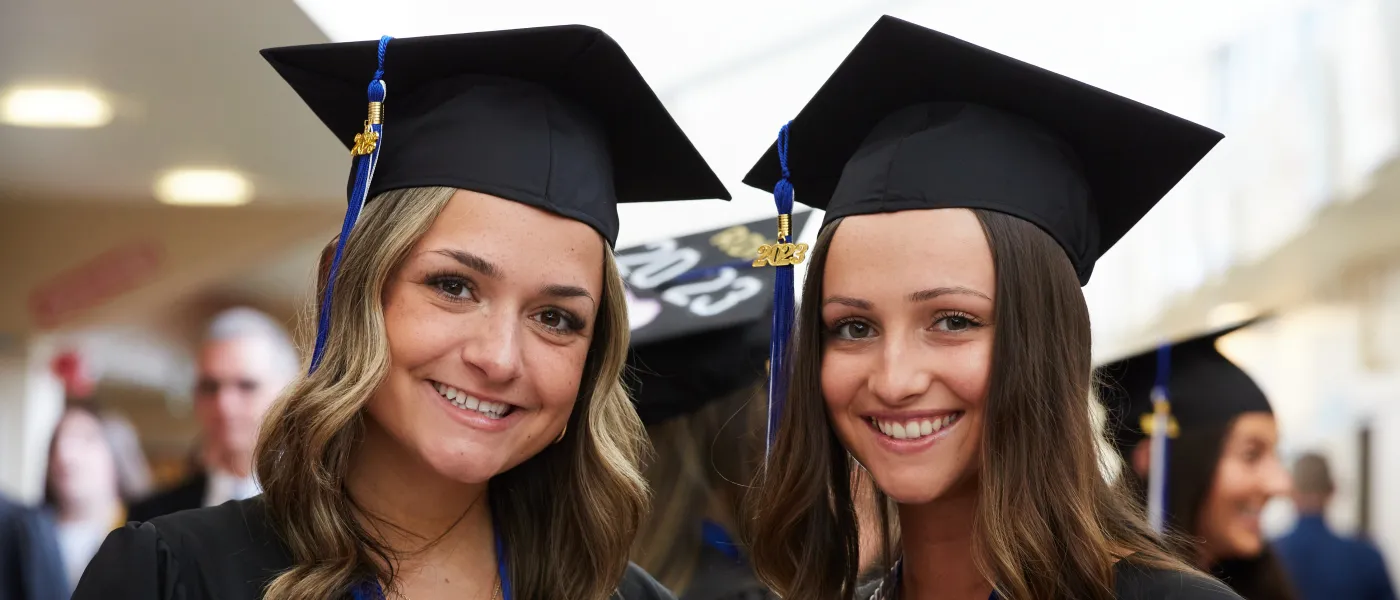 UNE graduates pose at the Cross Insurance Arena in Portland