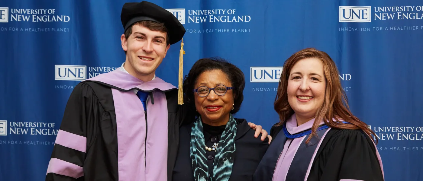 UNE graduates pose at the Cross Insurance Arena in Portland