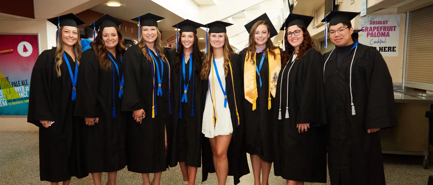 UNE graduates pose at the Cross Insurance Arena in Portland