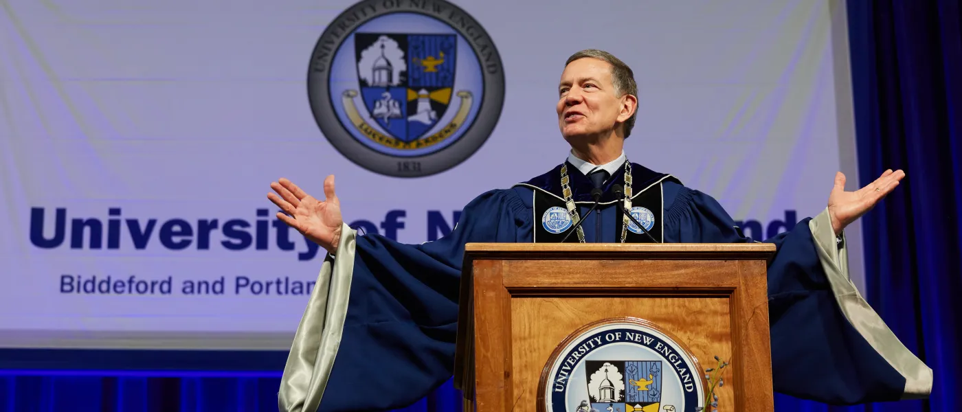 UNE President James Herbert speaks at the podium