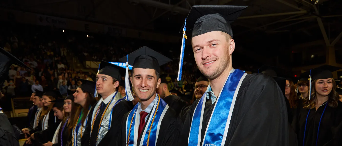 UNE graduates pose at the Cross Insurance Arena in Portland