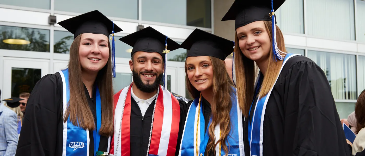 UNE graduates pose at the Cross Insurance Arena in Portland