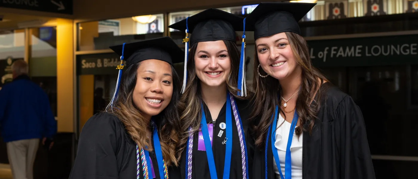UNE graduates pose at the Cross Insurance Arena in Portland