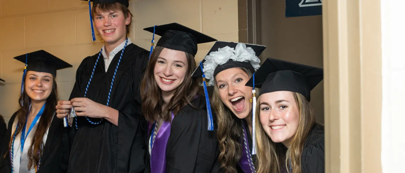UNE graduates pose at the Cross Insurance Arena in Portland