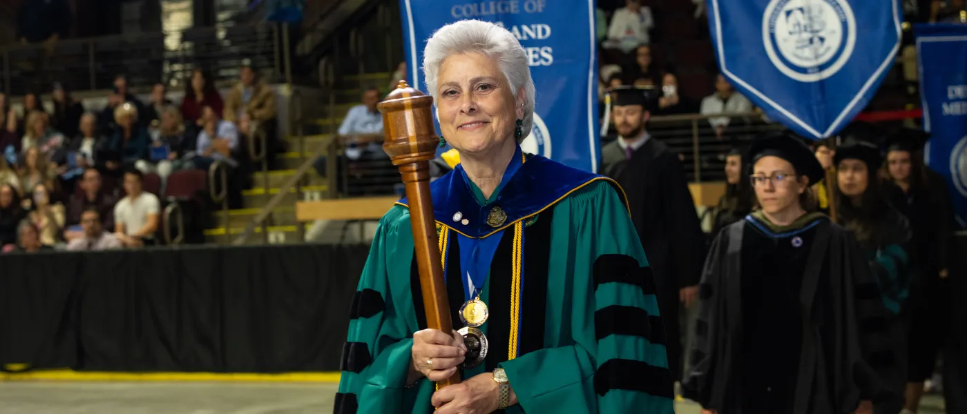 Prof. Marilyn Guggliuci bears the University mace