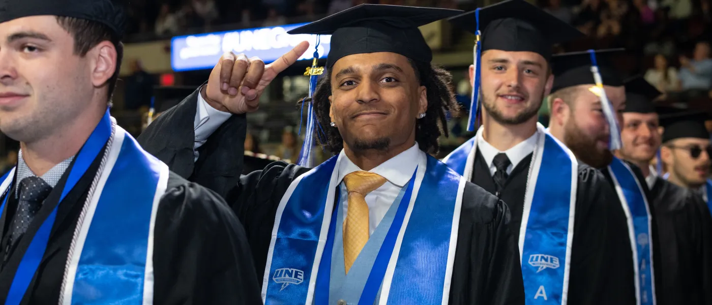 UNE graduates march at Cross Insurance Arena in Portland