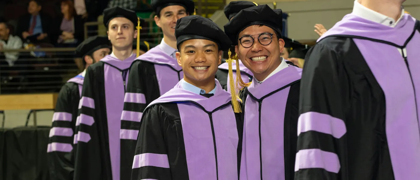 UNE graduates march at Cross Insurance Arena in Portland