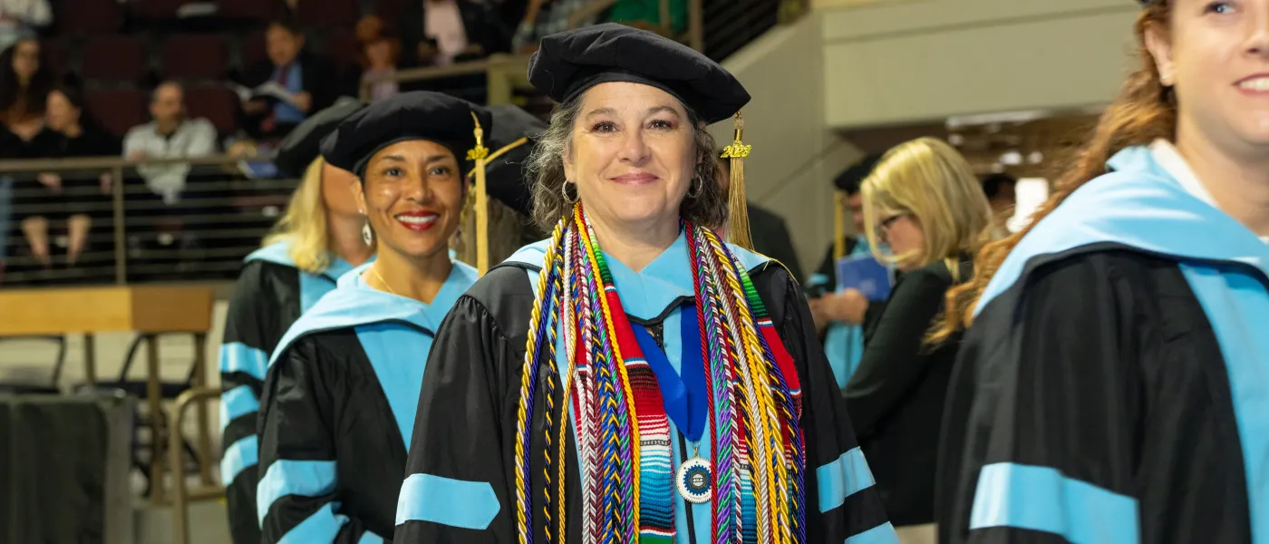 UNE graduates march at Cross Insurance Arena in Portland