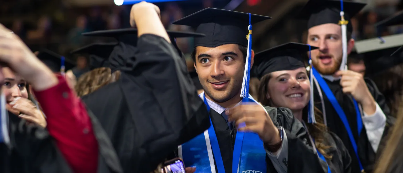 UNE graduates cheer at the Cross Insurance Arena in Portland