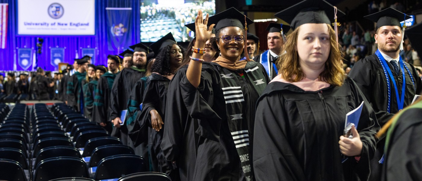 UNE graduates march at the Cross Insurance Arena in Portland