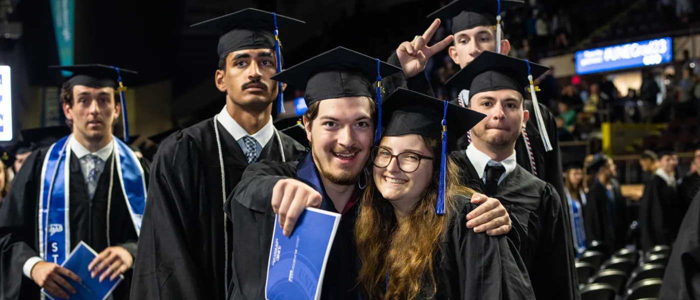 UNE graduates pose at the Cross Insurance Arena in Portland
