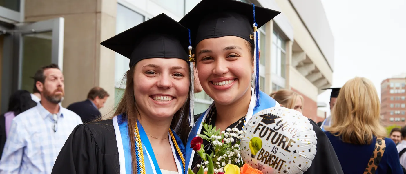 UNE graduates pose at the Cross Insurance Arena in Portland