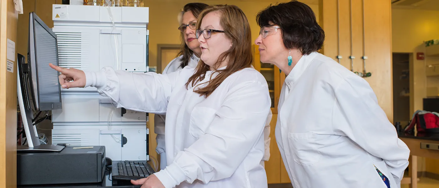A student points to research data on a computer screen