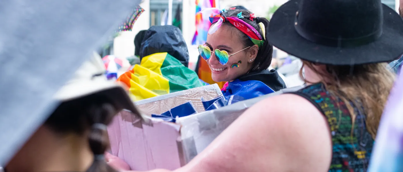 A UNE student smiles as she gathers for the parade
