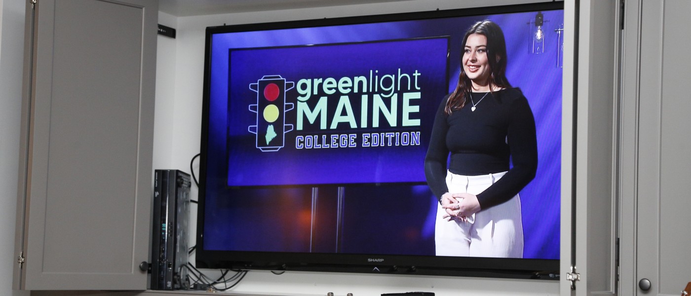 Anderson is shown on the TV screen against the "Greenlight Maine" backdrop