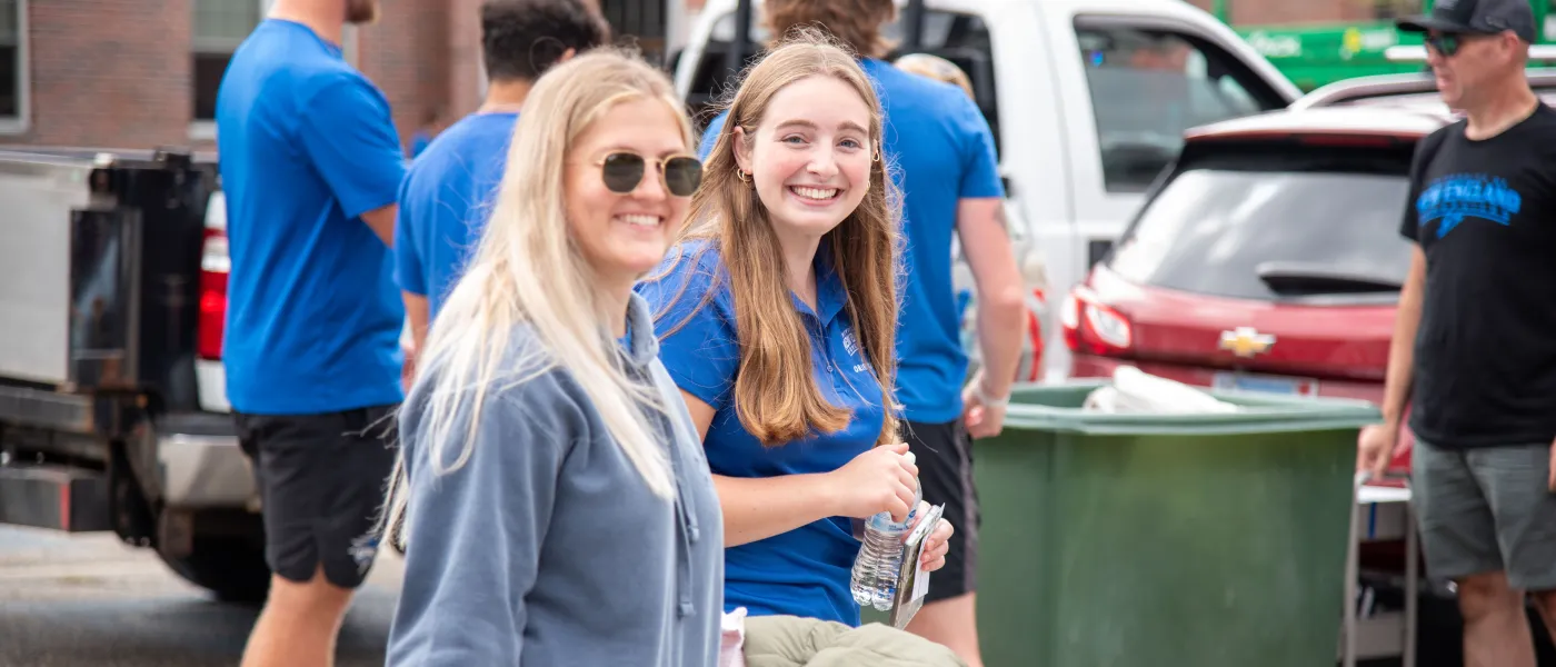 Two female students smile for a photo