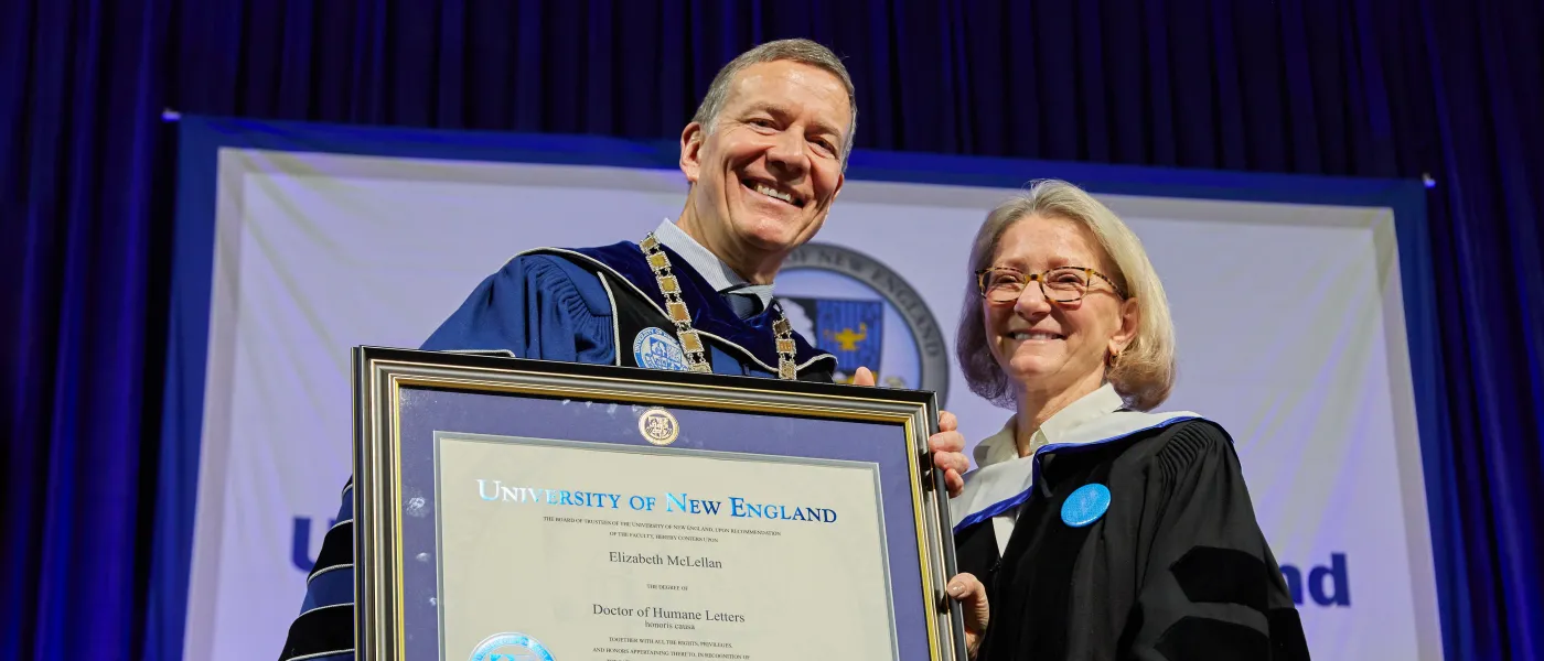 U N E's president James Herbert presents an award at the 2023 commencement ceremony