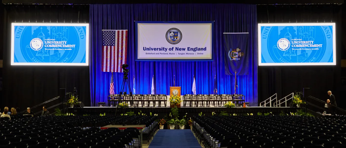 A crowd of students seated at U N E's 2023 commencement ceremony