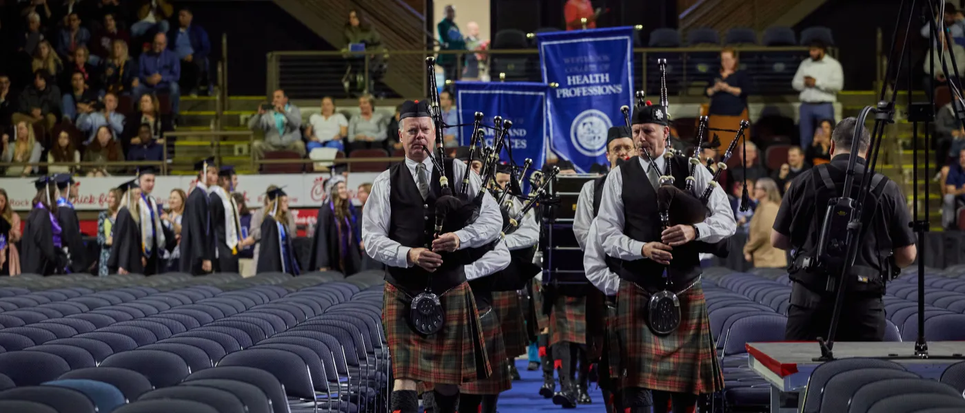 Bagpipers walk down the aisle at commencement