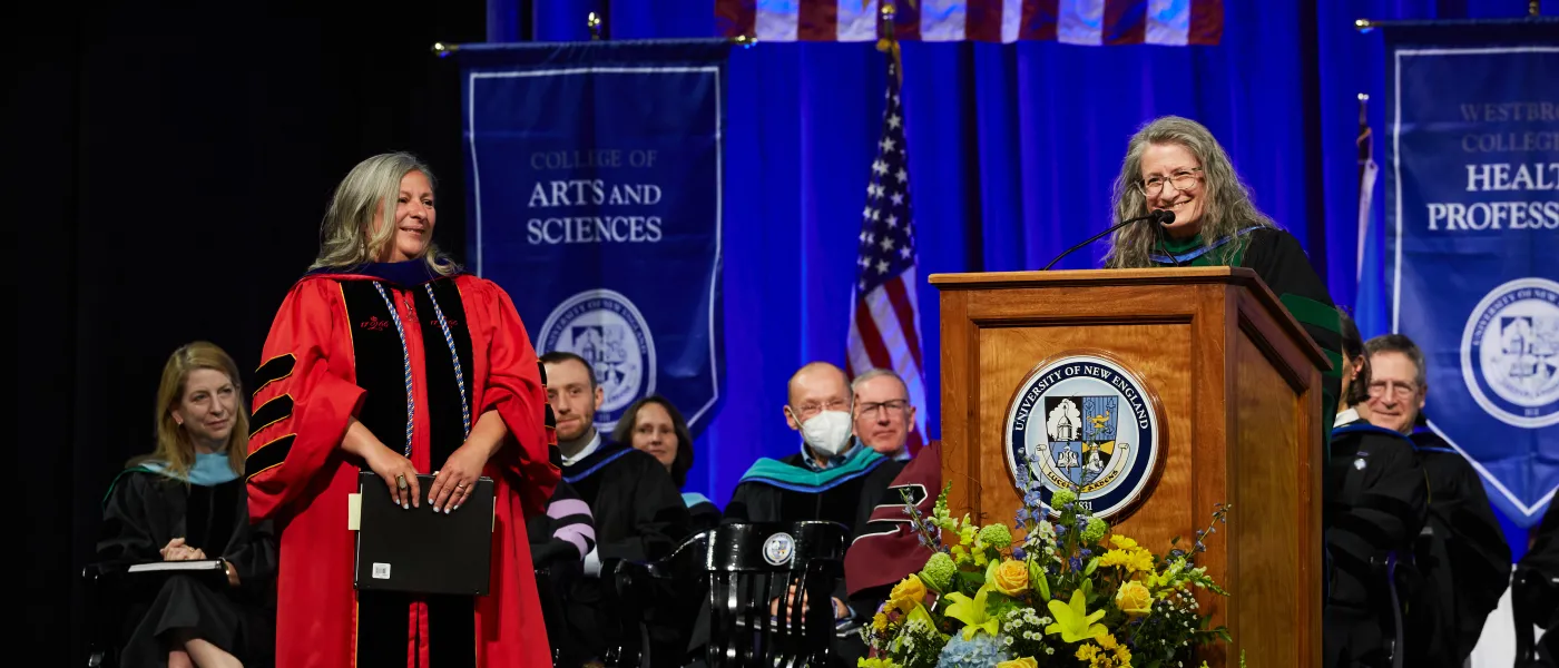 Faculty on stage at the 2023 commencement ceremony