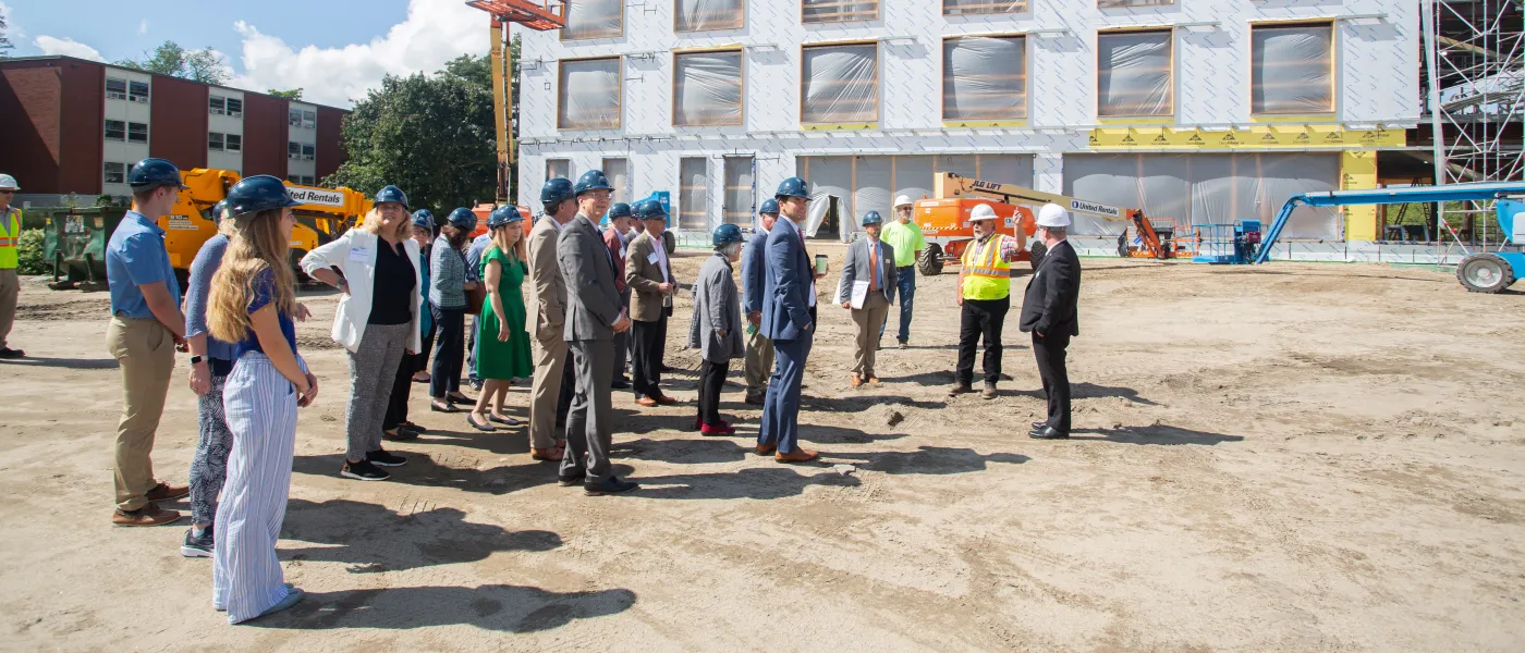 A crowd gathers outside the construction of the new health sciences building on U N E's Biddeford campus