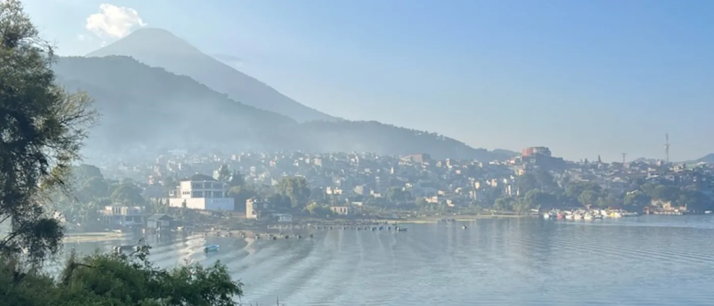 A small town sits at the base of a mountain by a lake