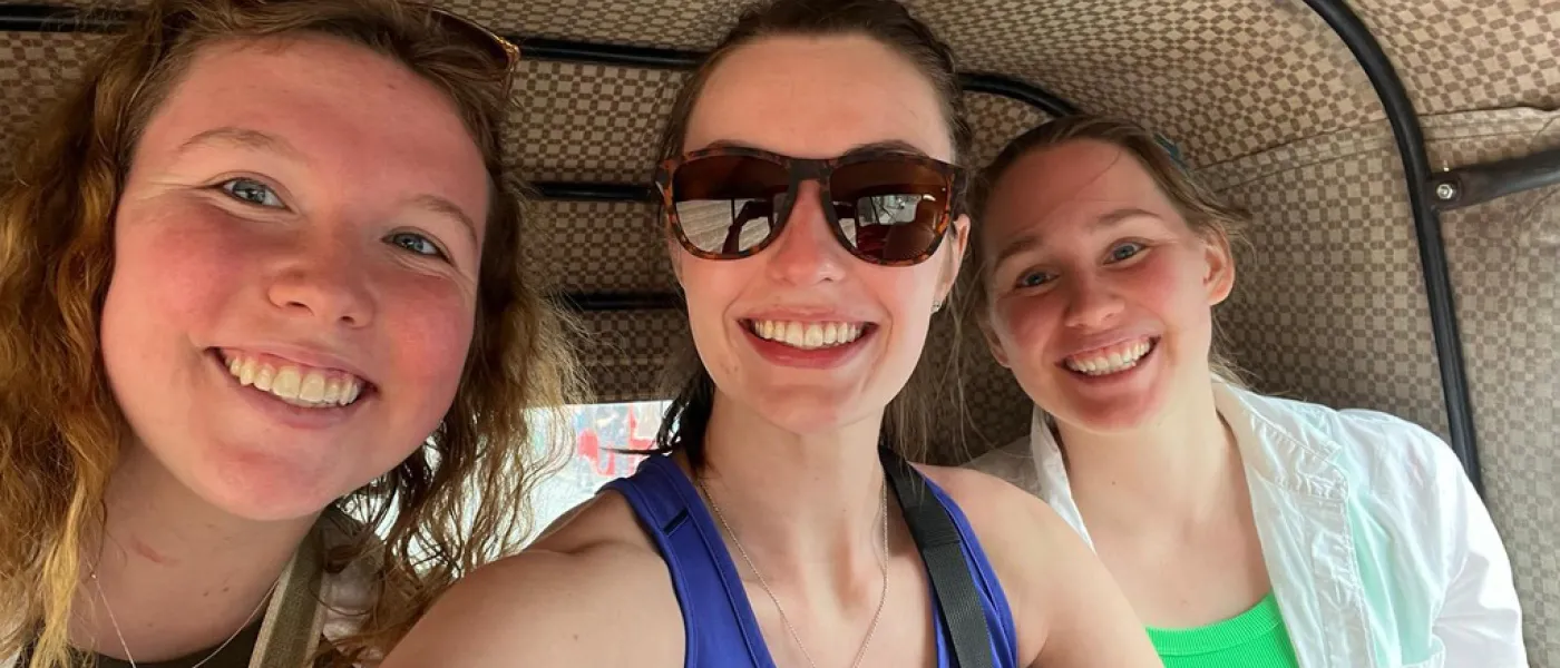 Three friends smile in a selfie