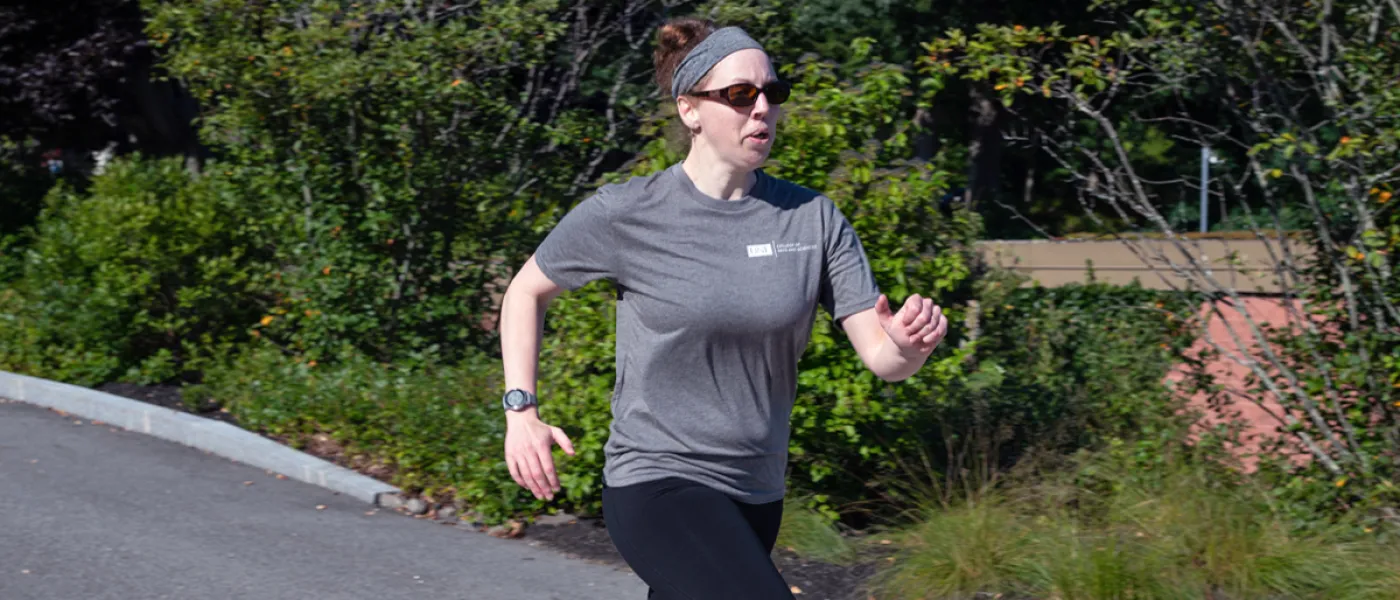 U N E employee jogging on the Biddeford Campus