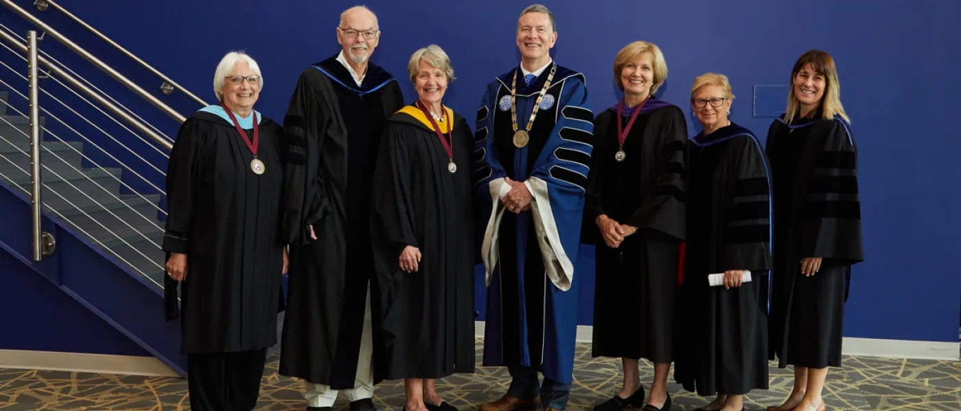President Herbert stands with the two Deb Morton recipients and other U N E faculty members