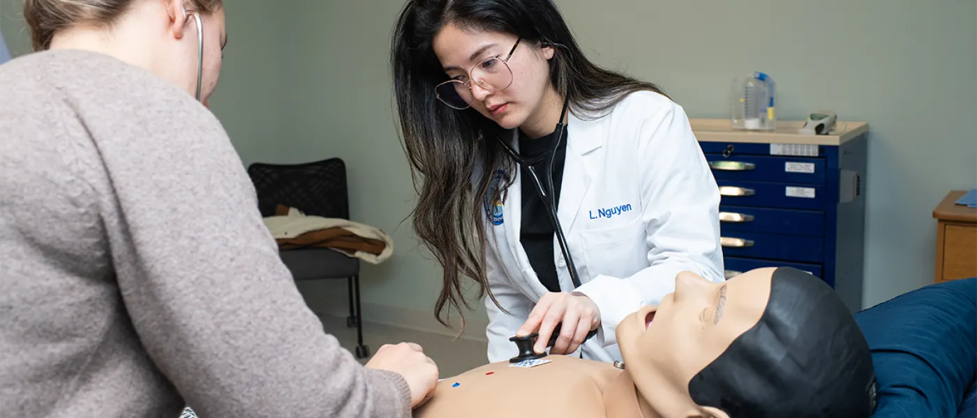 P A students practice listening to cardiac sounds in a skills lab